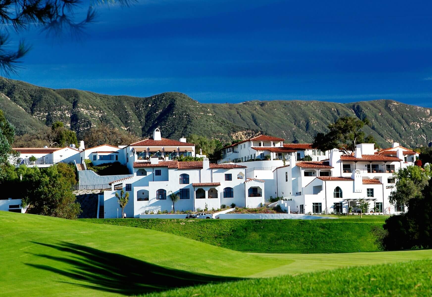 External view of Ojai Valley Inn's Resort complex with a mountain ridge backdrop