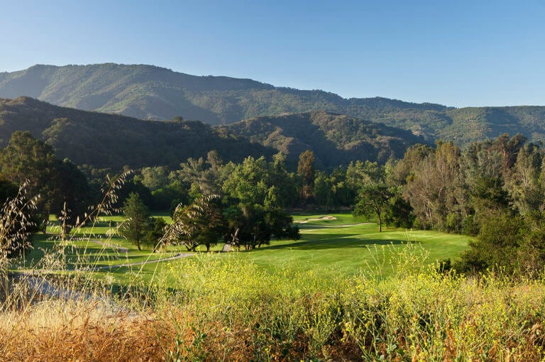 Rolling mountainous backdrop frames a picturesque golf course at Ojai