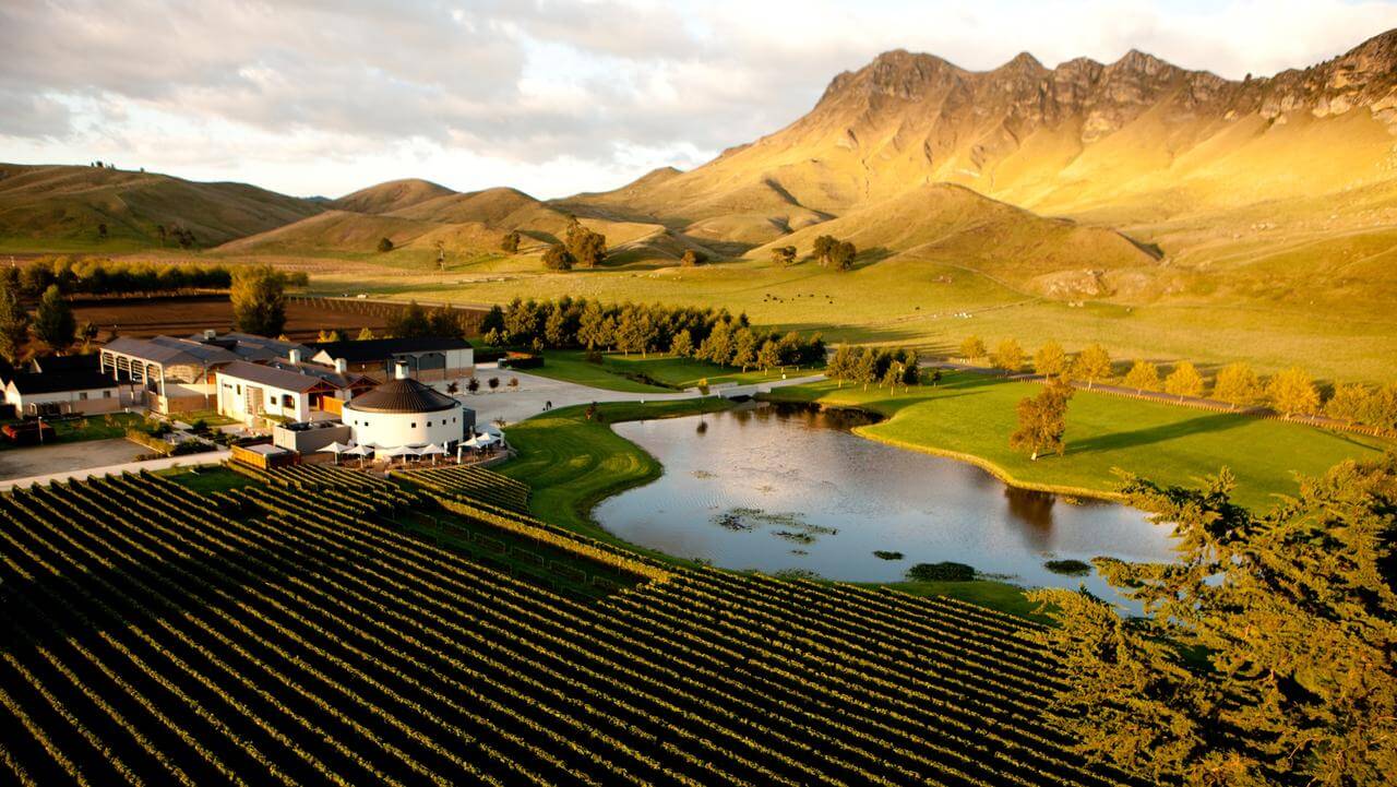 Aerial view of a winery and sun-kissed mountain backdrop in New Zealand's Hawke's Bay