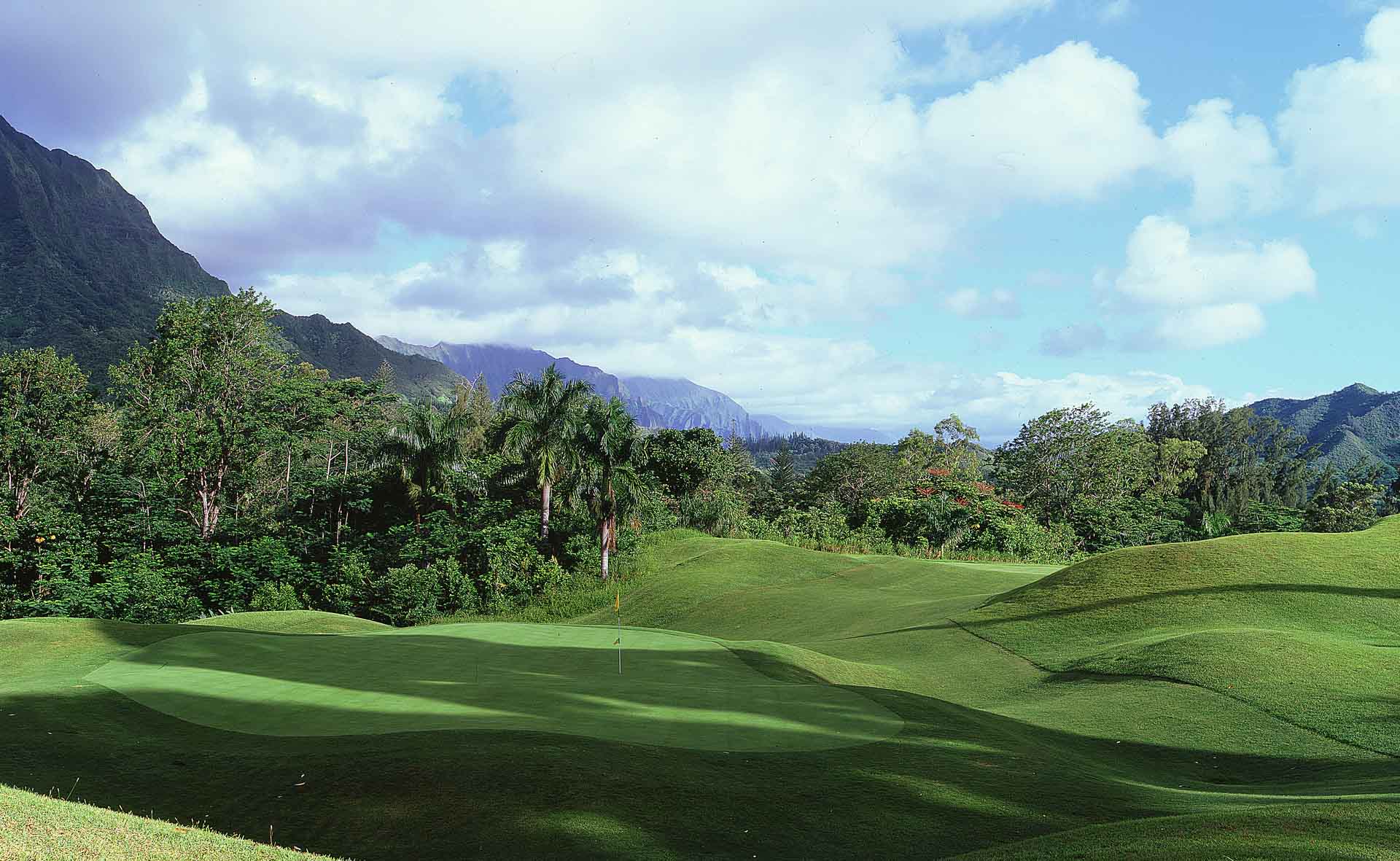 Lush greens and fairway feature on the first hole of the Royal Hawaiian Golf Club