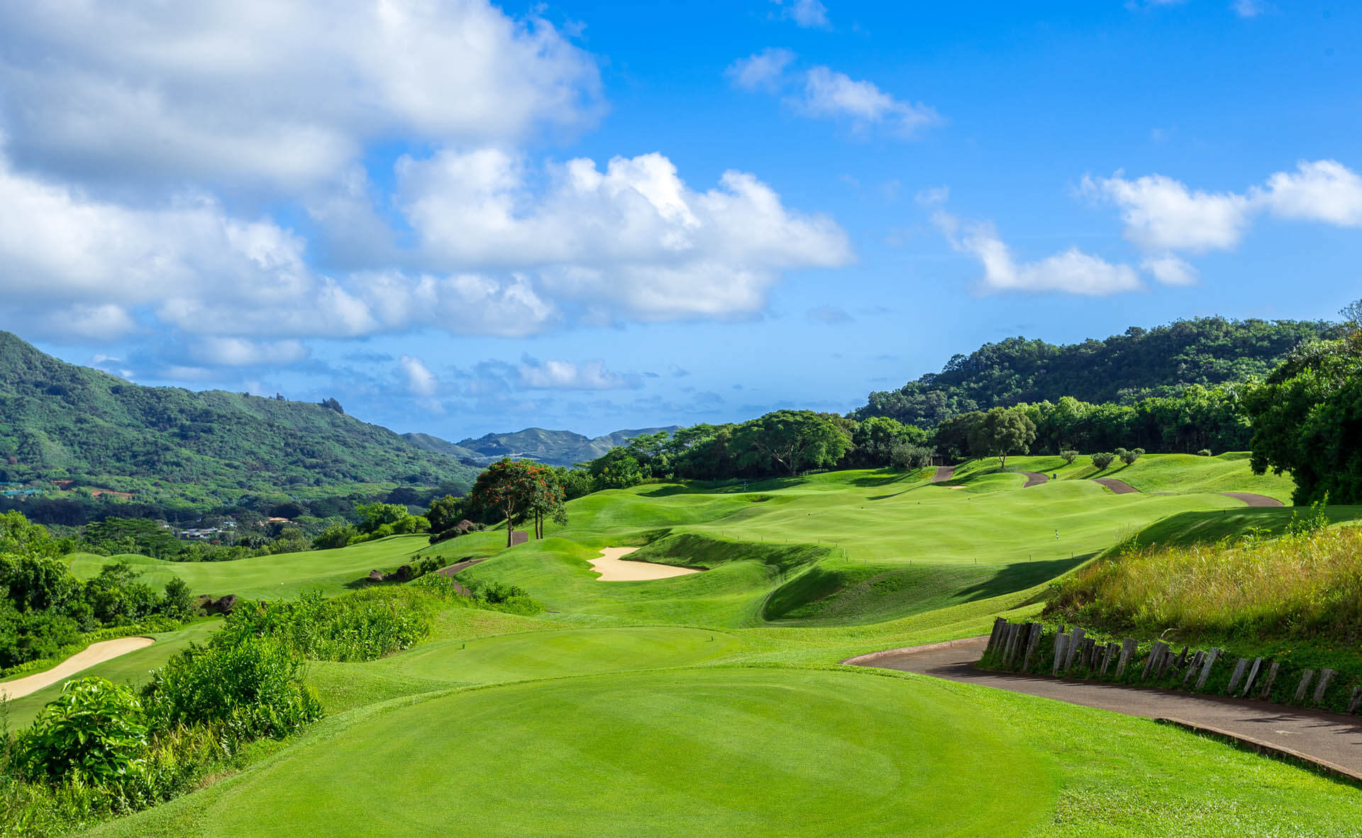 Open fairways overlook distant lush valleys on Oahu