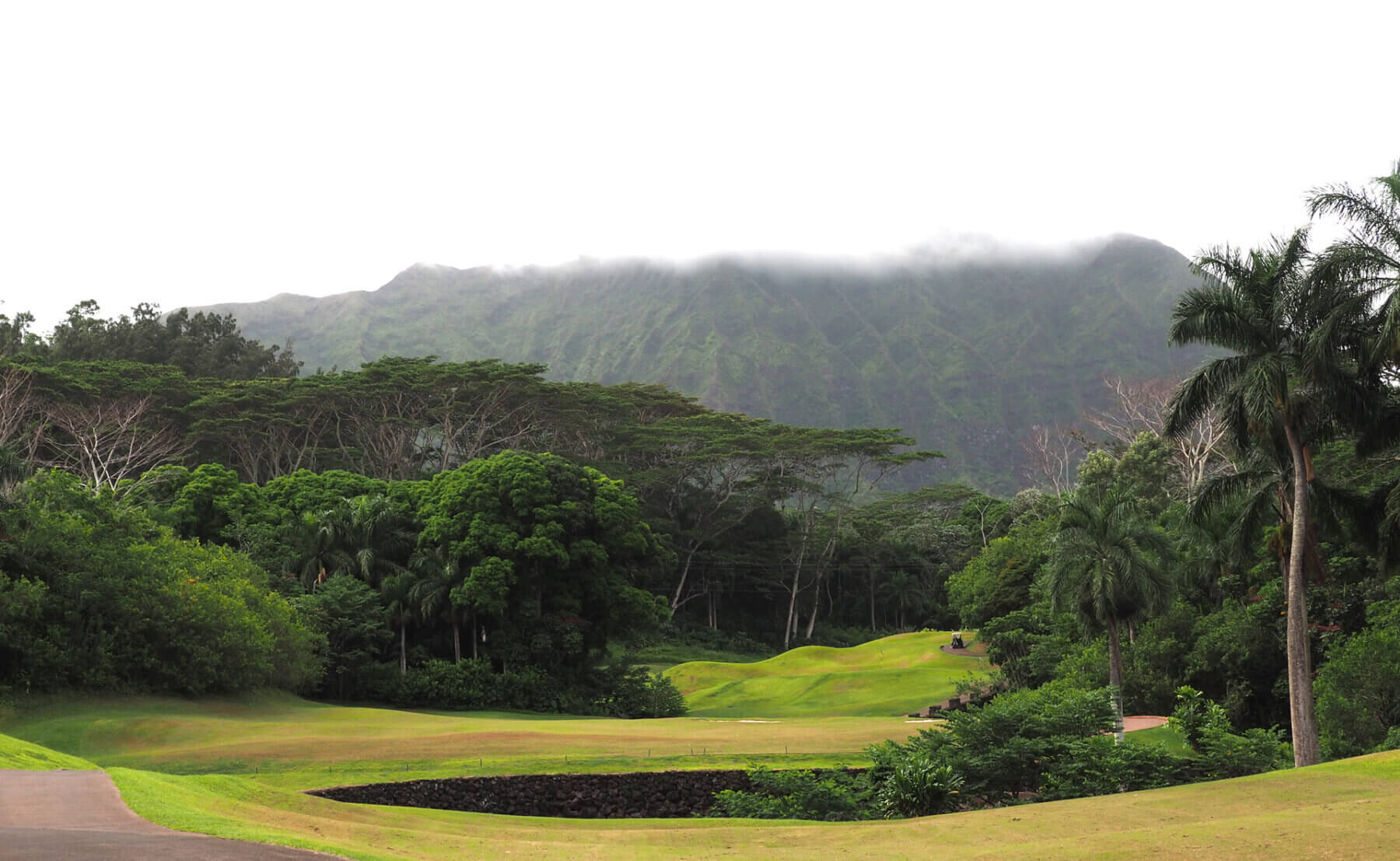 Clouds cover the top of the mountains above the fourth hole