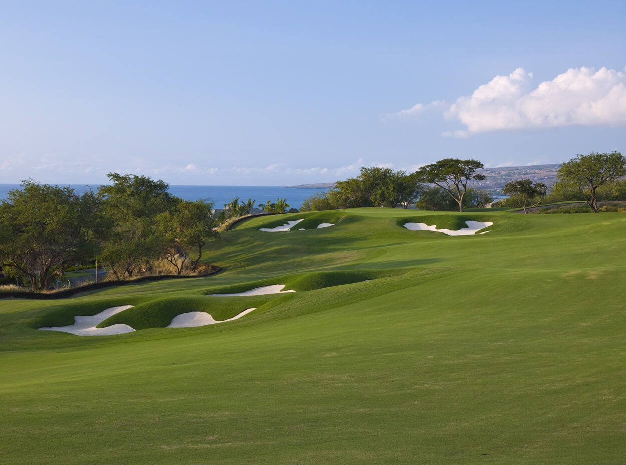 Wide open fairway leads to an elevated green at Mauna Kea golf course