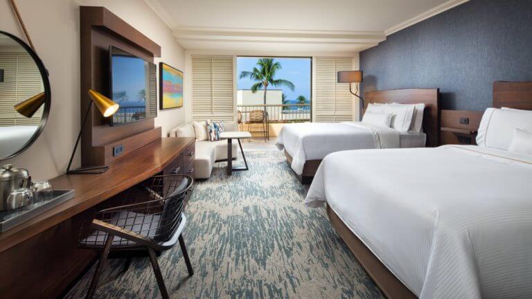 Twin beds and contemporary furniture adorn an Oceanview guestroom
