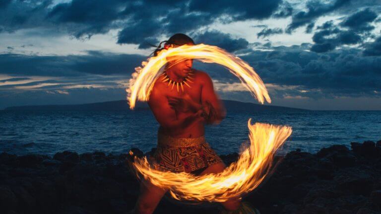 A native Hawaiian dances with fire at a Luau show at Wailea Beach Resort