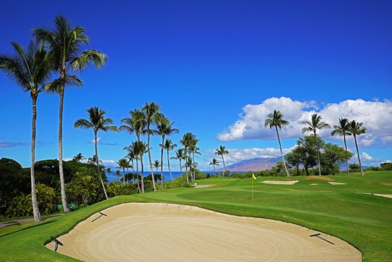 A large bunker overlooks a green and distant Lanai in Hawaii