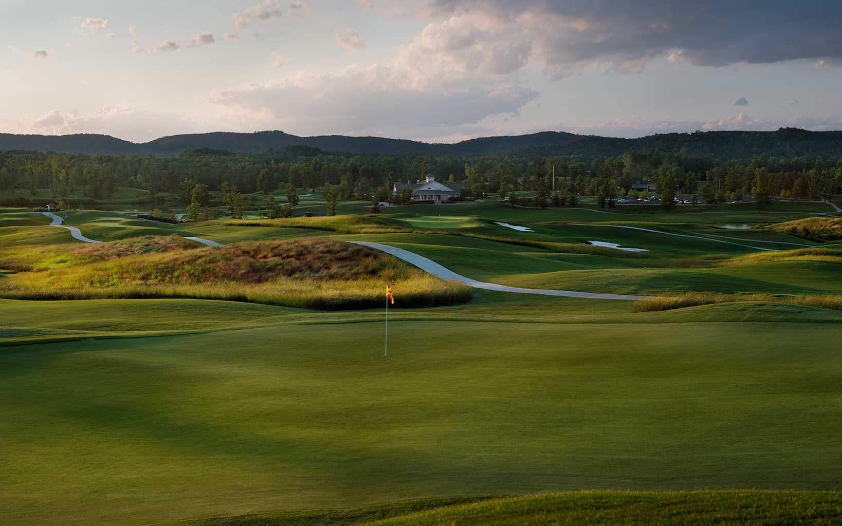 Overlooking a green on the first hole with the distant clubhouse at Silver Lakes Golf Club