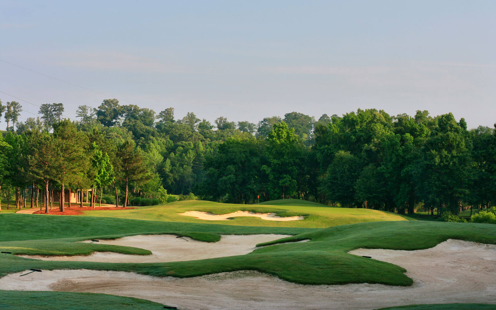 Large flat-bottomed sand bunkers display Robert Trent Jones Senior's preferred golf course design
