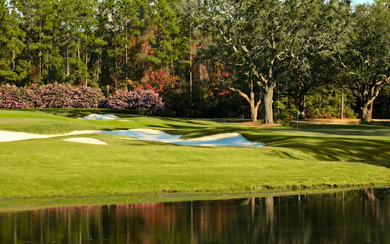 A lake resides next to the fourth green on the Dogwood Golf Course