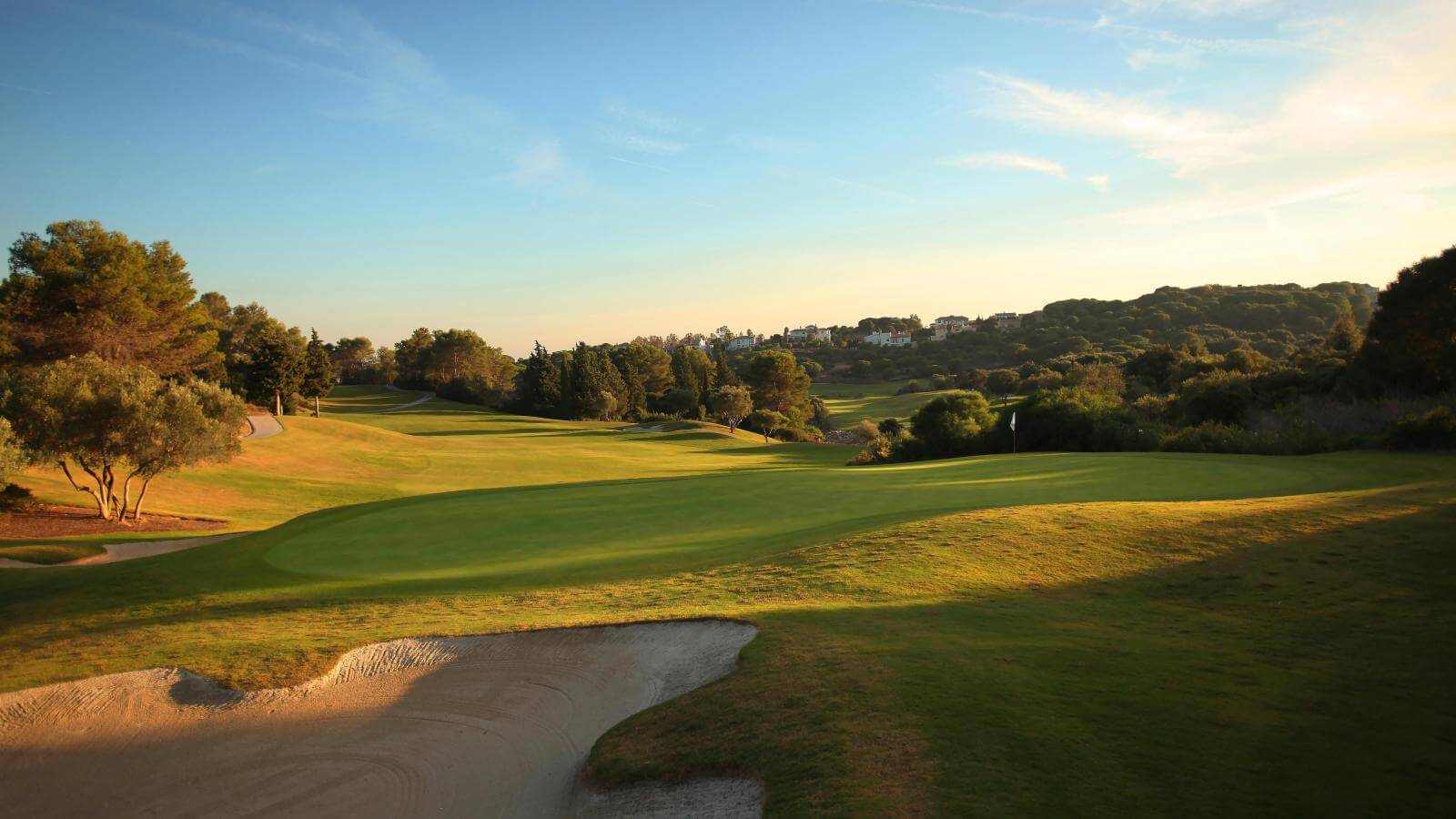 The second hole fairway slopes downhill onto a large green
