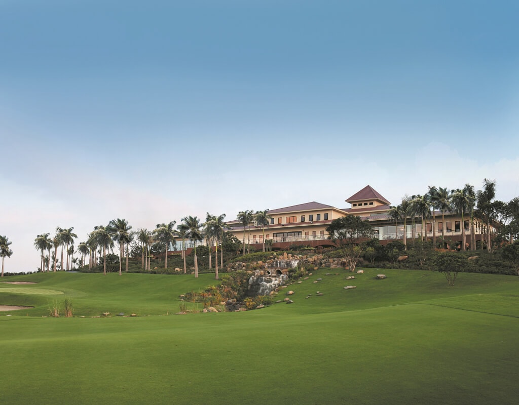 Large clubhouse stands overlooking the golf course