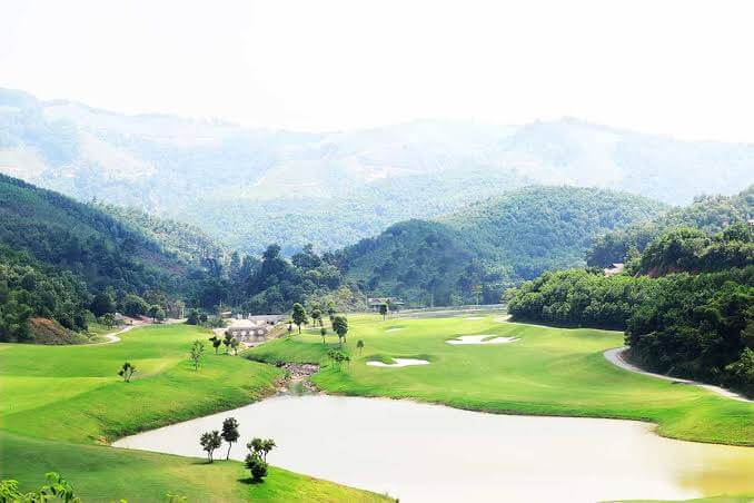 Mountains rise behind the golf course at Hilltop Valley