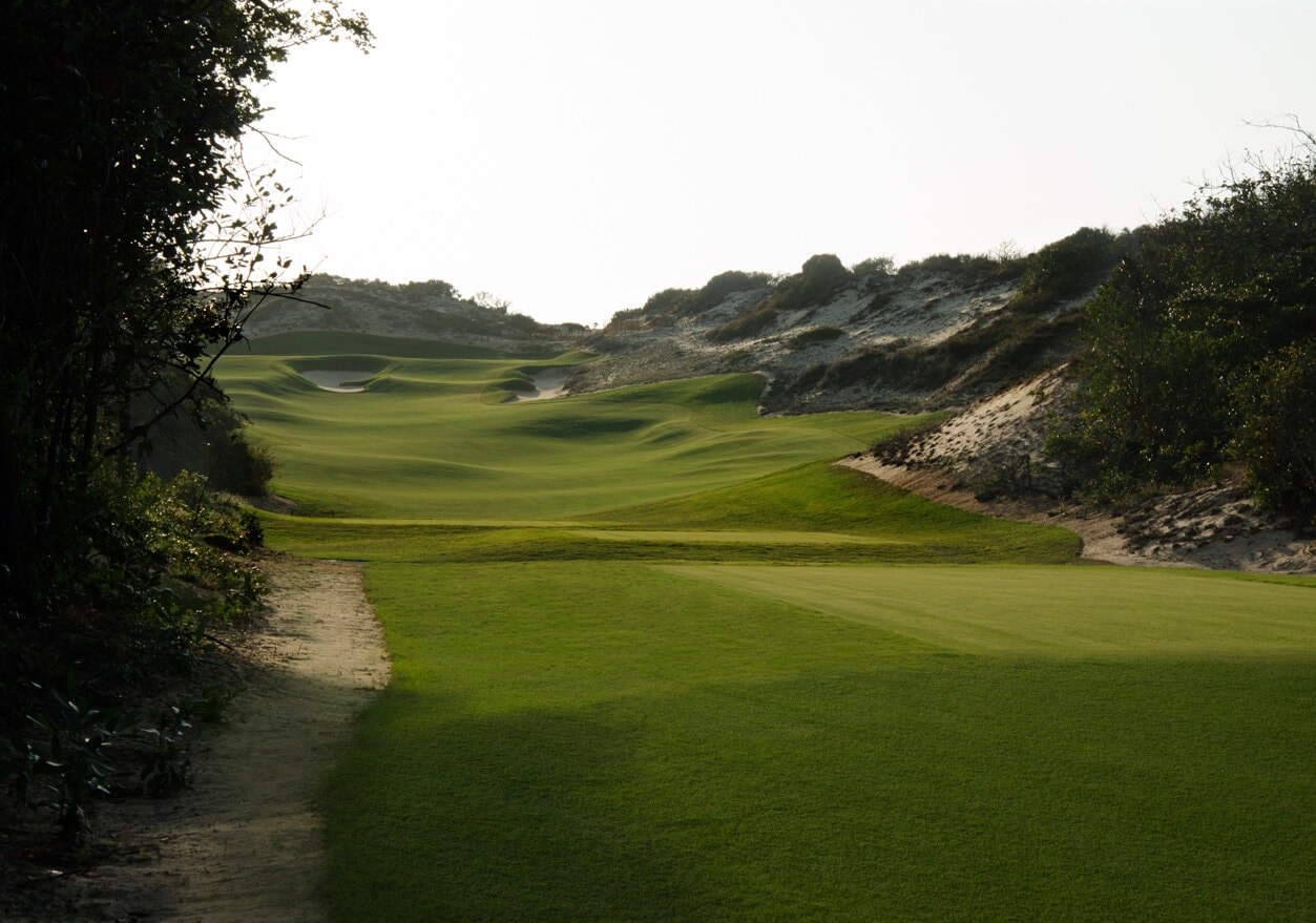Undulating terrain runs through large sand dunes