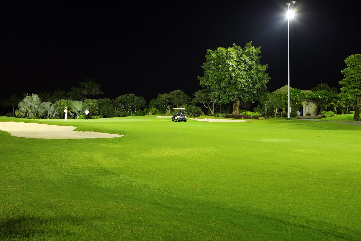 Golfers play on the Hill Course at night with special lighting