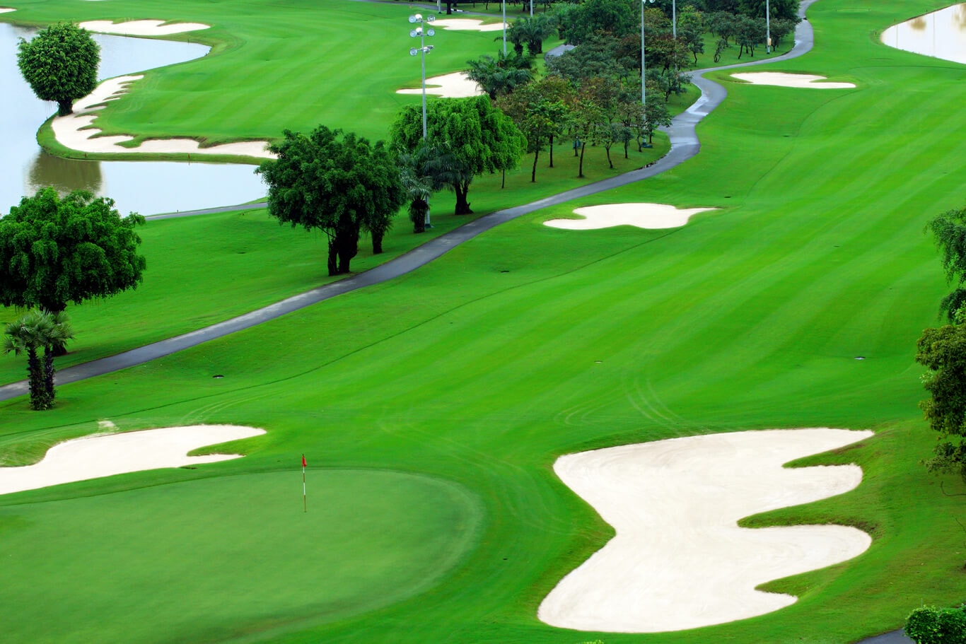 Large white bunkers contrast with green fairways at Long Thanh Golf Club in Vietnam