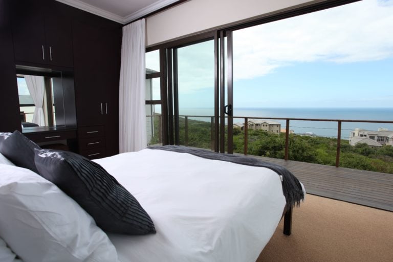 Large double bed opens to a balcony and Ocean views