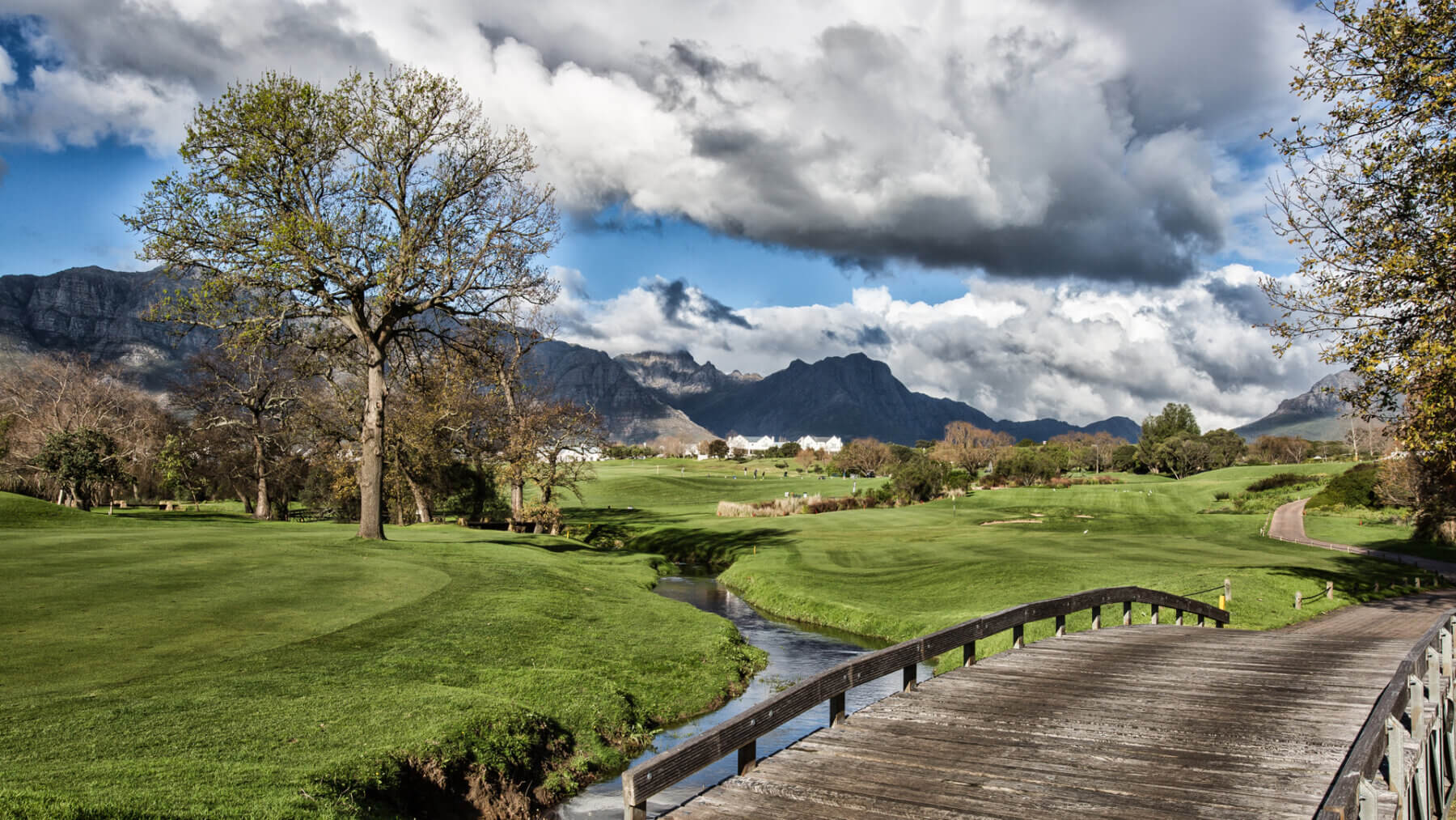 A wooden bridge over a meandering river