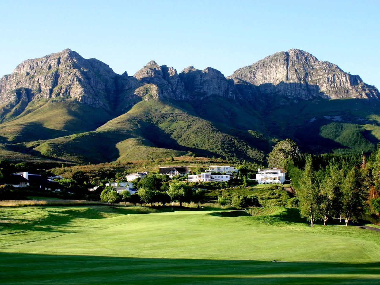 The golf course resides at the base of a mountain