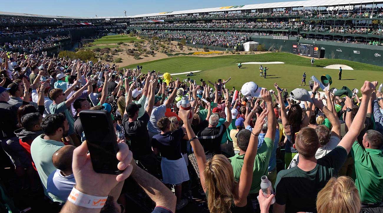 Fans watch the par-3 sixteenth hole on the Stadium Course