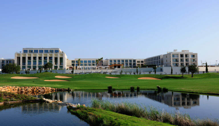 Resort building with pool and golf course view