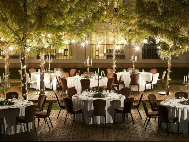 Night dining under trees with candles