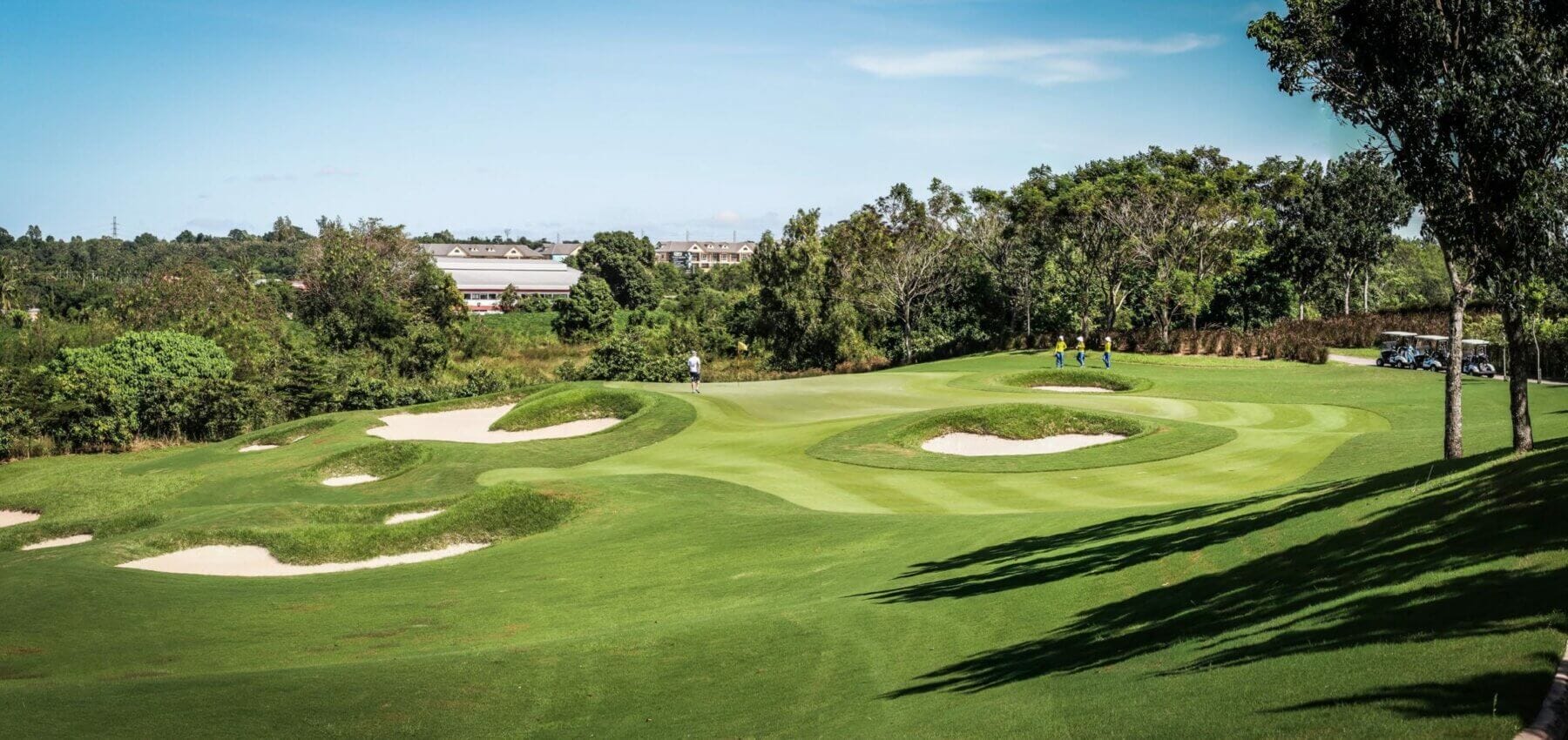 Downhill par 3 to green protected by many bunkers