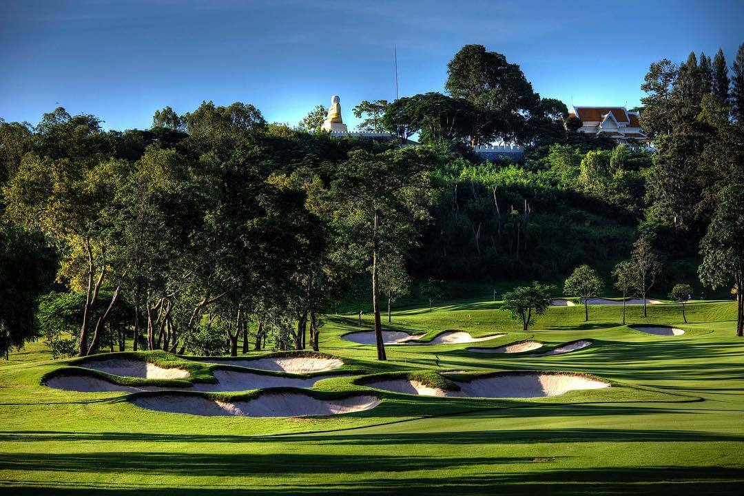 Large bunkers with giant Buddha overlooking the course
