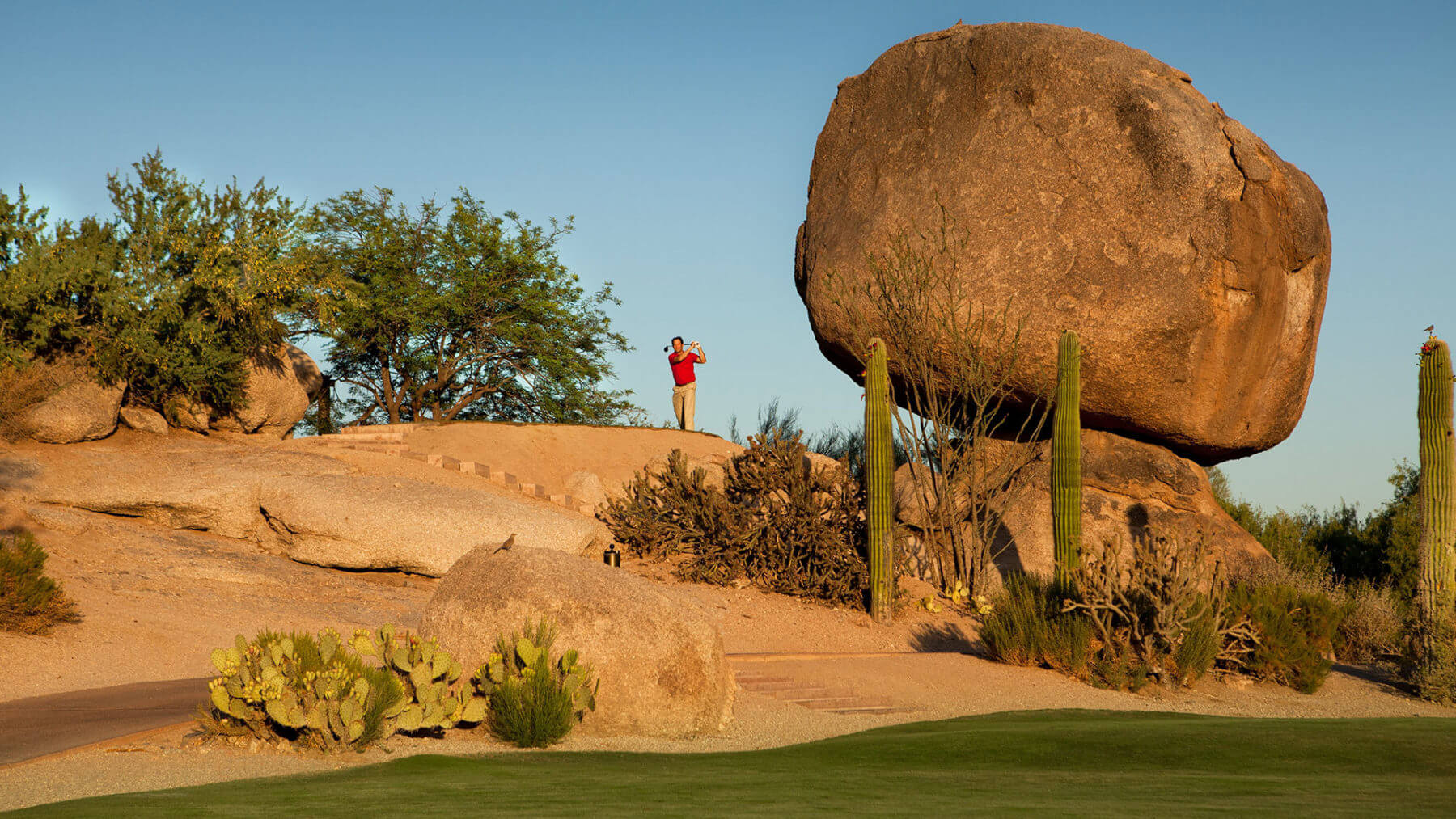 Man tees off from behind Rosies Rock