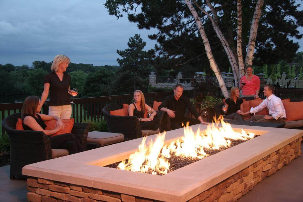 Golfers gather around a fire pit