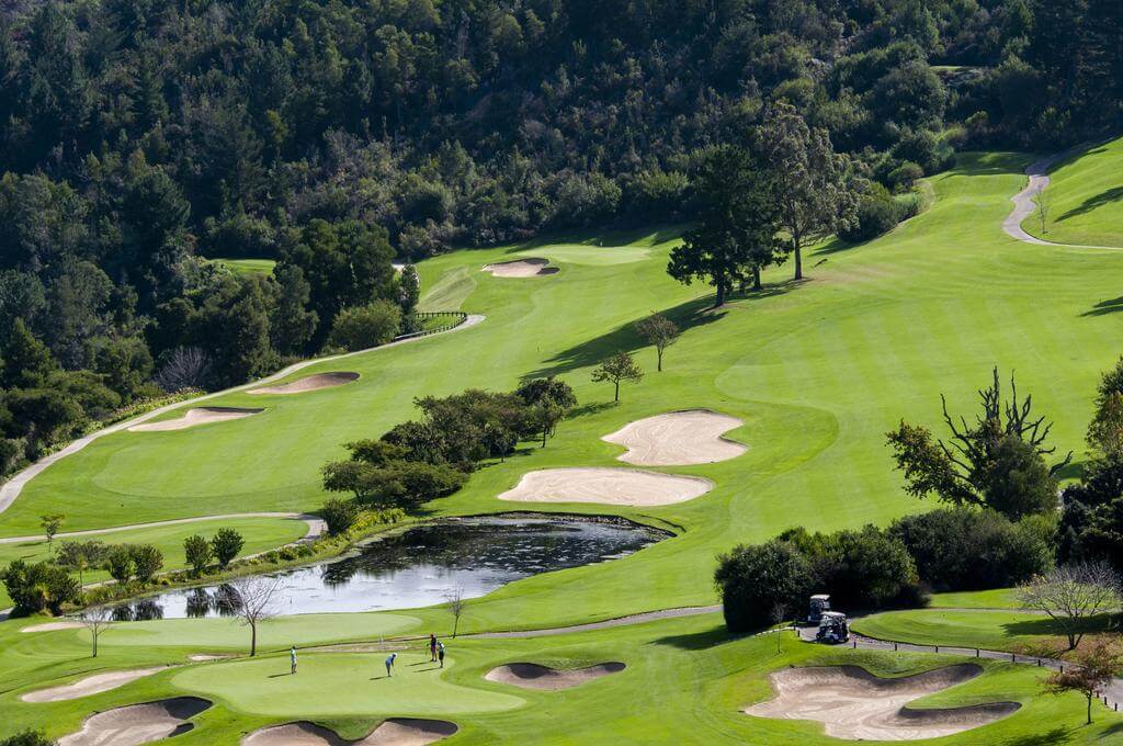 Golfers on green on the golf course at Simola Estate